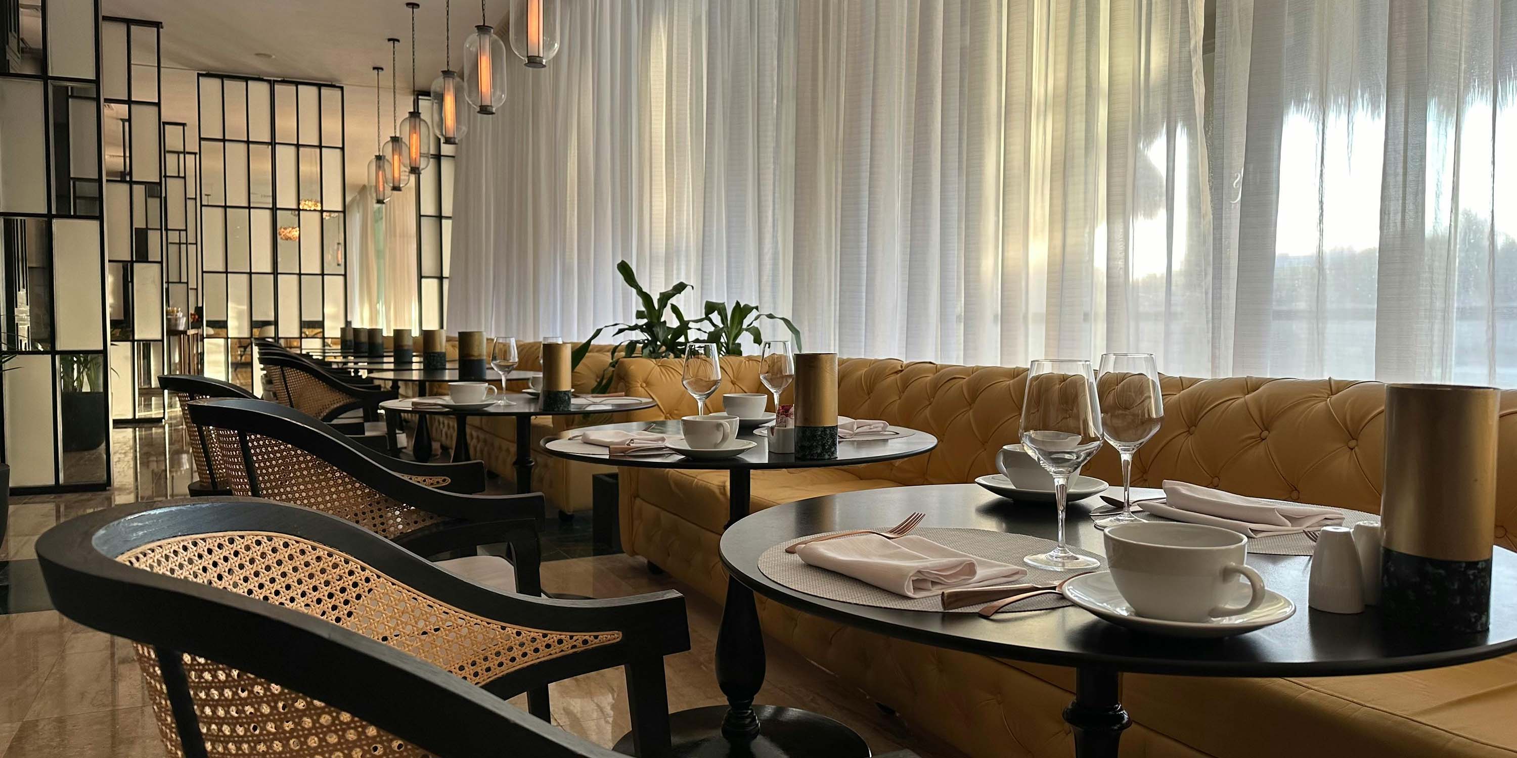 golden toned restaurant with paneled wall dividers and curtains drawn