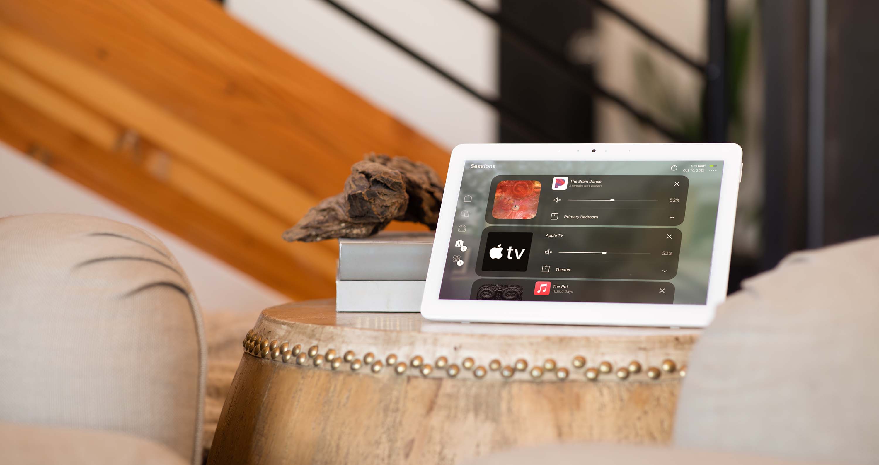 Control4 Touch panel in a able with a traditional home in the background