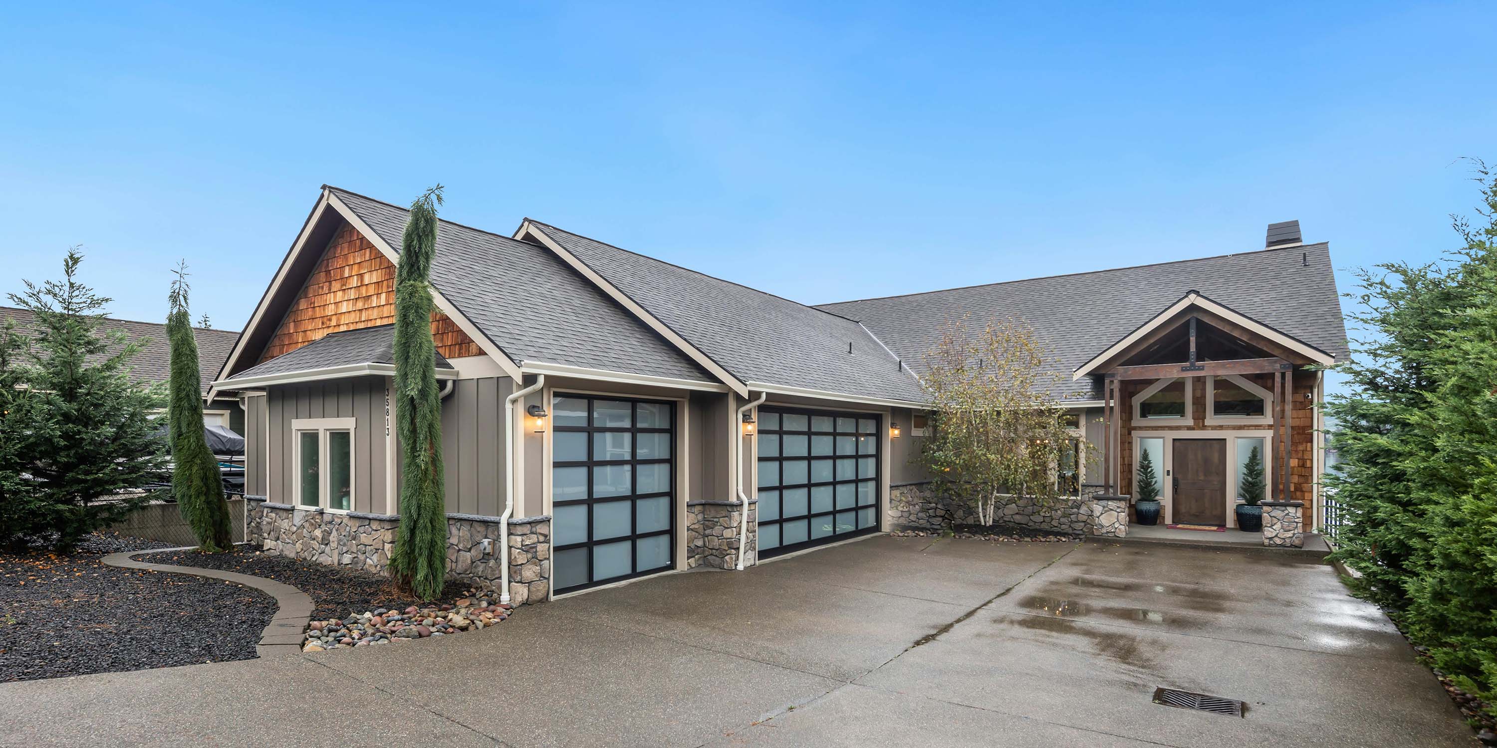 mountain home with luxury garage doors and rock paneling
