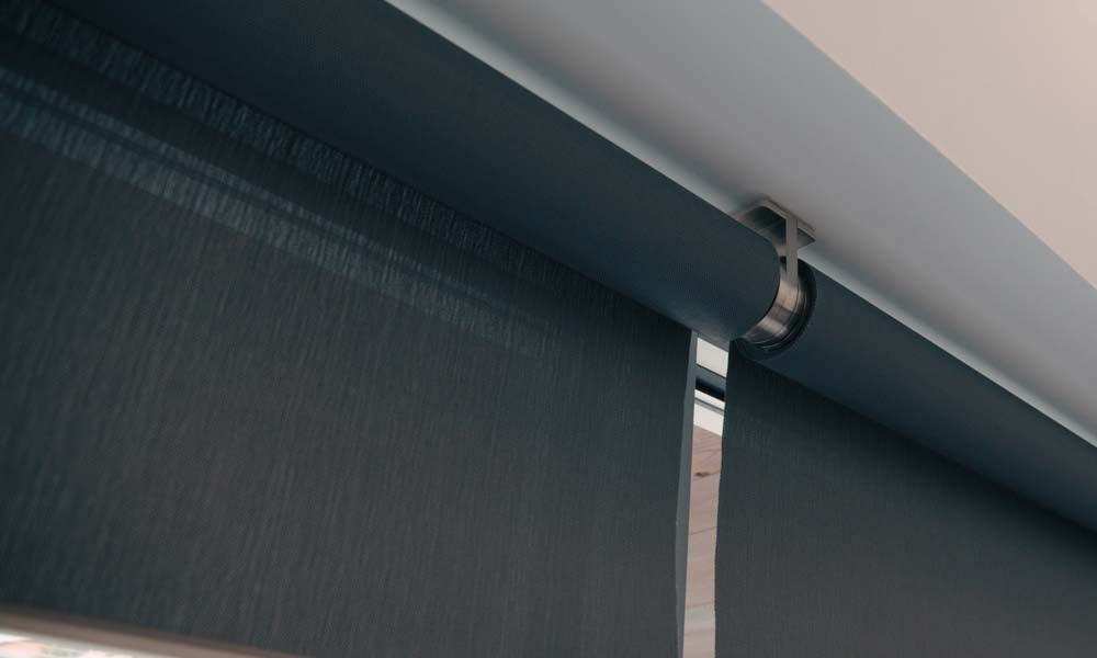 Close-up of modern roller shades mounted on ceiling