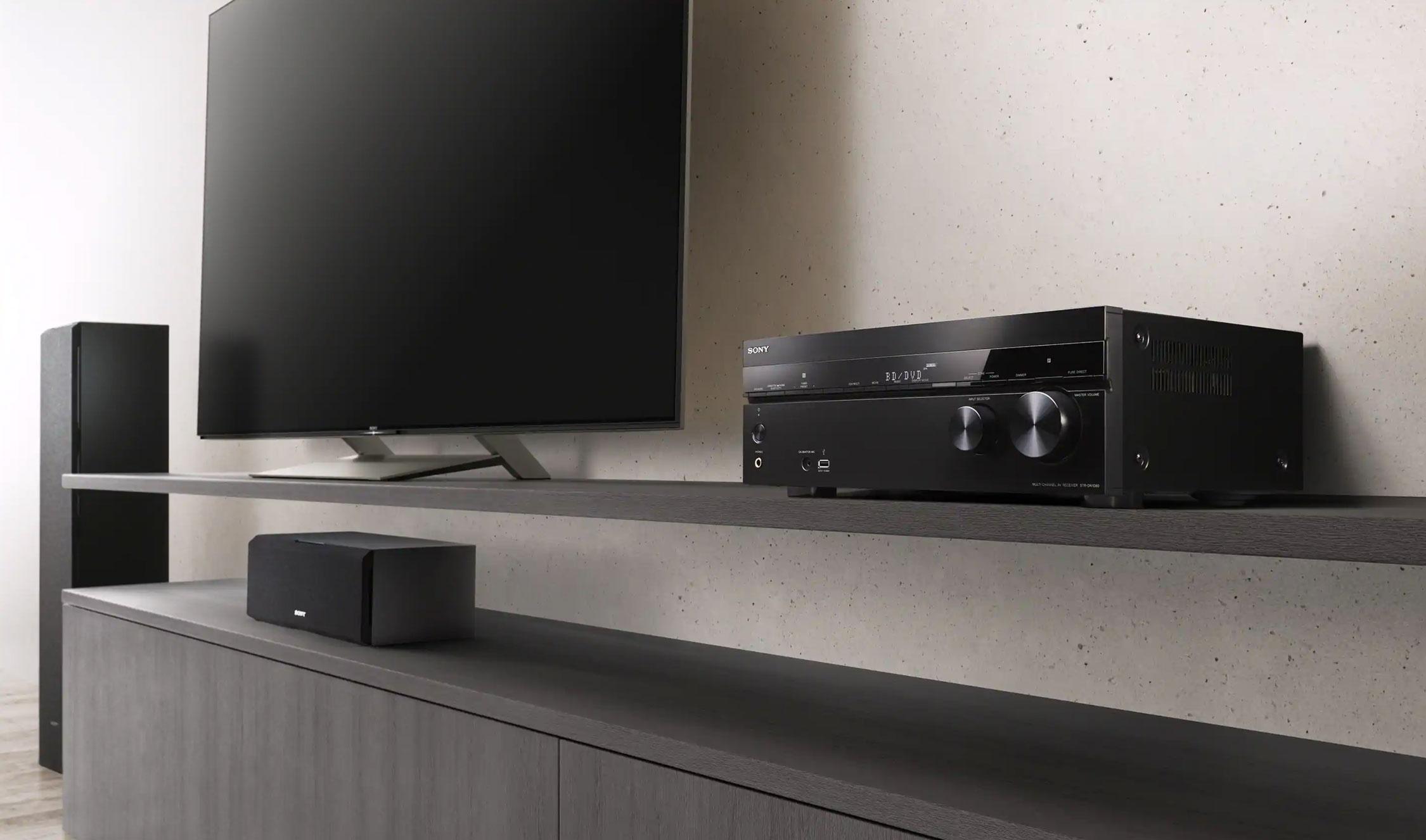 A Sony home entertainment setup featuring a flat-screen TV, an audio receiver, and speakers on a modern shelf.