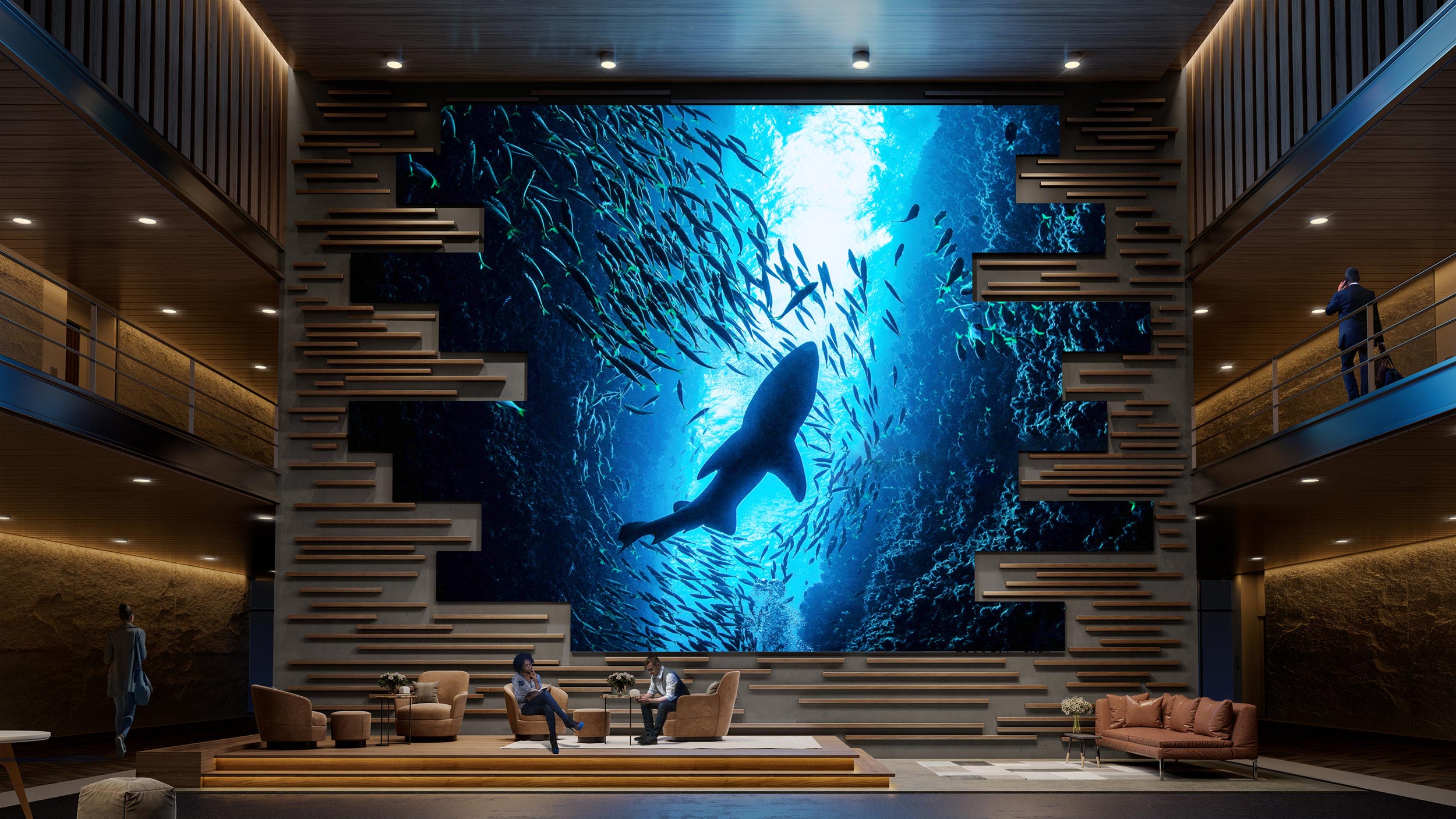 A large Sony video wall showcasing an underwater scene with a shark silhouette, displayed in a modern, stylish atrium with seating and wooden accents.